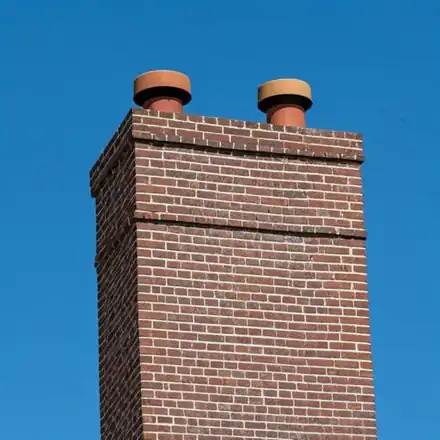 High-contrast photo of a beautifully restored brick chimney on a classic American suburban home in Anoka, MN